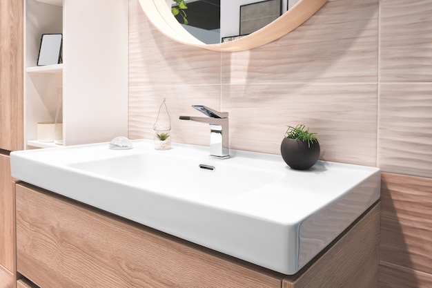 Luxury faucet mixer in interior of beautiful bathroom.