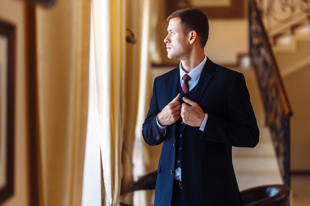 Luxury groom in suit Businessman The morning of the groom bridegroom's fees Sexy man in suit posing