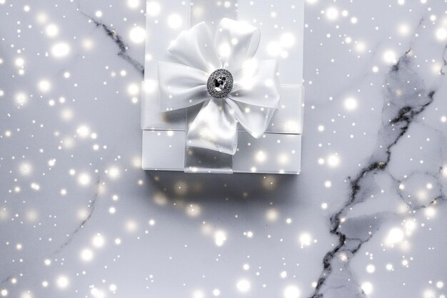 Luxury holiday gifts with white silk bow and ribbons on marble background Christmas time surprise