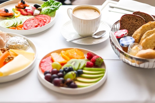 Luxury hotel and five star room service various food platters bread and coffee as inroom breakfast for travel and hospitality