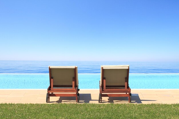 Luxury hotel swimming pool in front of the sea