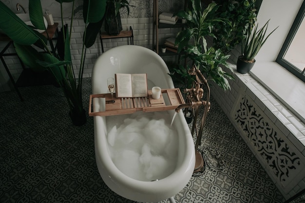 Luxury interior of big bathroom at modern african style with oval bathtub in natural lighting
