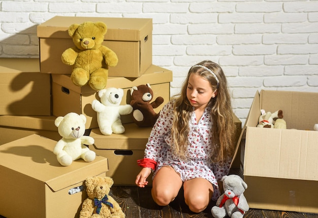 Luxury is affordable playing into new home new apartment Cardboard boxes moving to new house happy child cardboard box happy little girl with toy purchase of new habitation