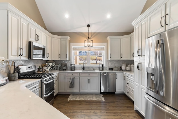 Luxury kitchen with white cabinetry and chrome appliances