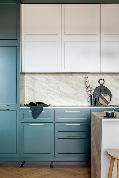 Luxury modern and vintage turquoise and white kitchen Marble wall with white cabinets Black vase with white dried flowers Template