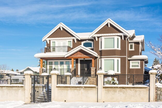 Luxury residential house in snow on winter sunny day in canada