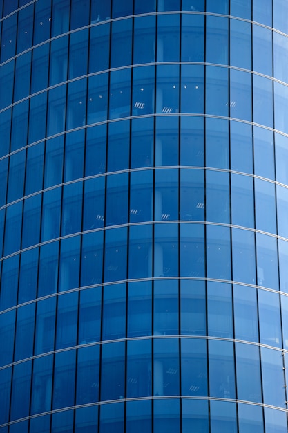 Luxury skyscraper with glass high windows. Blue toned.