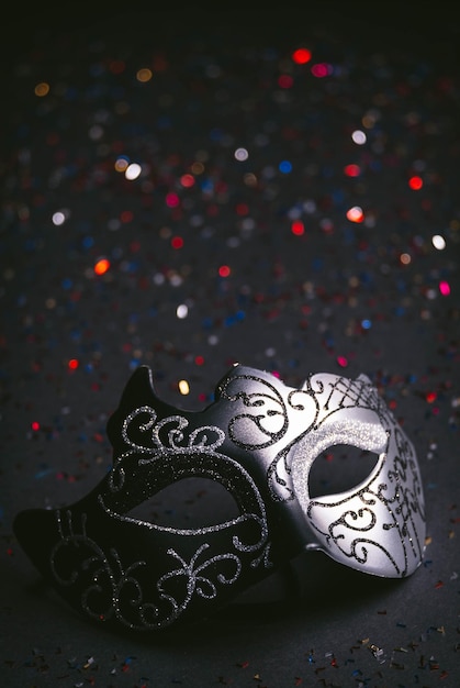 Luxury venetian mask on dark colored bokeh background