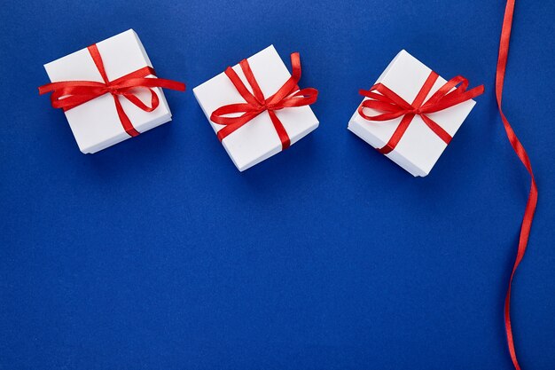 Luxury white gift boxes with red bows