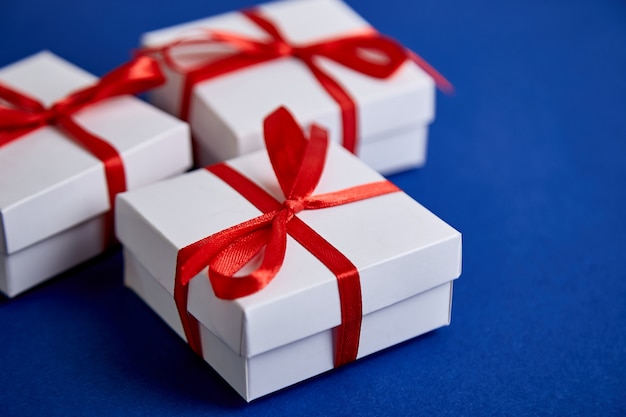 Luxury white gift boxes with red ribbon