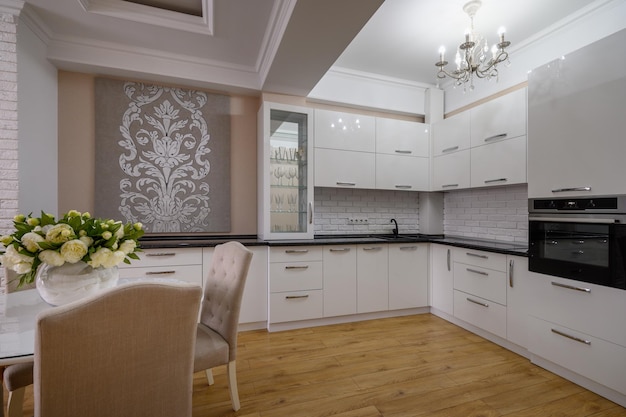 Luxury white modern kitchen with rose walls in studio apartment