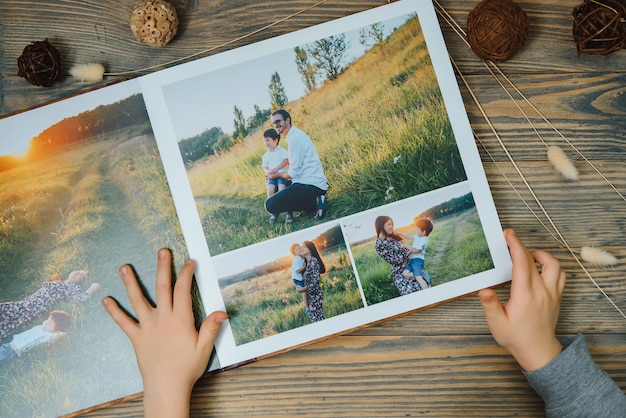 Luxury wooden photo book on natural landscape. Family memories photobook. Save your summer vacation memories.