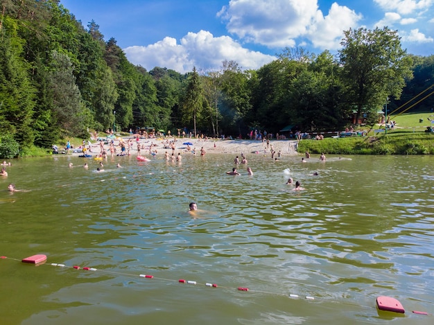 LVIV UKRAINE 9 JUNE 2018 people swimming in lake summer time