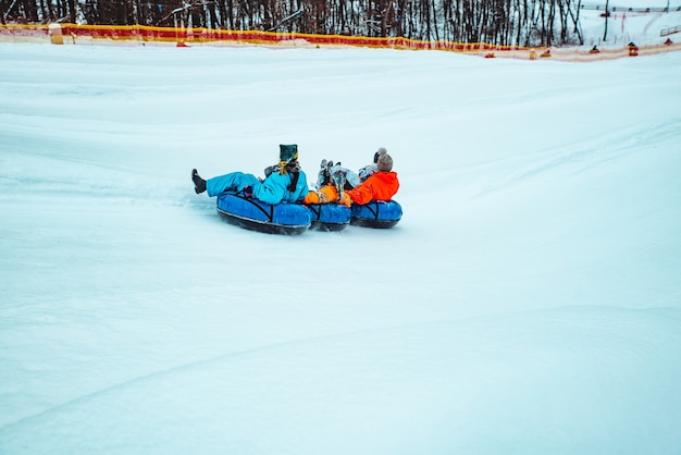 LVIV, UKRAINE - January 7, 2019: winter fun activities. ride down by hill on snow tubing. pushing