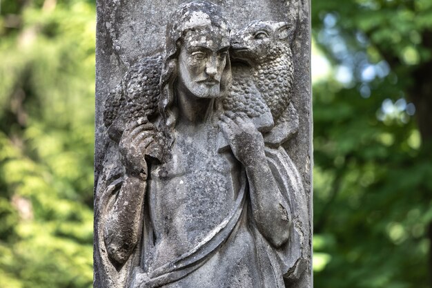 Lviv, Ukraine - May 25, 2020: Old Lychakiv Cemetery in Lviv. Old statue on grave in the Lychakivskyj cemetery