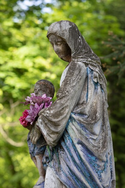 Lviv, Ukraine - May 25, 2020: Old Lychakiv Cemetery in Lviv. Old statue on grave in the Lychakivskyj cemetery