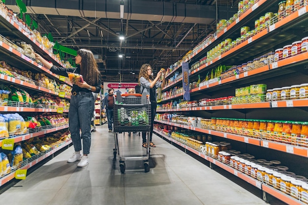 LVIV UKRAINE September 8 2018 two women choosing products in grocery store