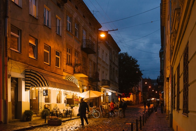 Lviv, Ukraine. Tourists walk through the evening old town