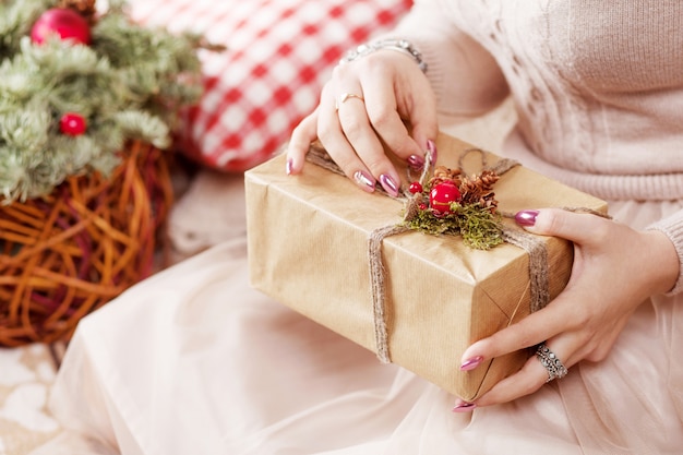 LWoman's  hands holding gift box. Christmas, new year . 