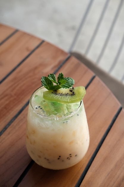 Lychee mocktail drink in a glass with small kiwi and mint leaves on top Selected focus