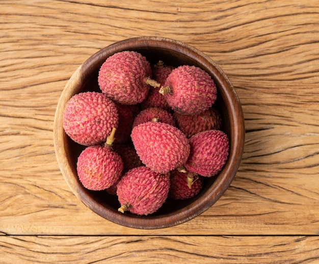 Lychees in a bowl over wooden table