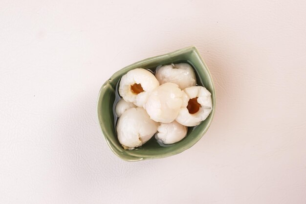 Lychees in syrup in a glass bowl