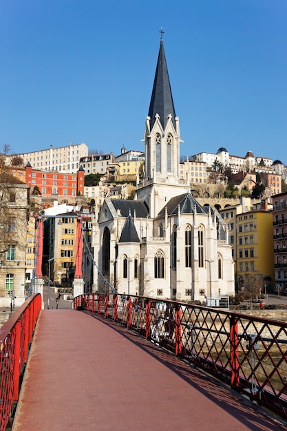 Lyon with famous red footbridge on Saone river and church