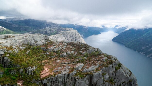 Lysefjord between high mountains on a cloudy day passing preikestollen