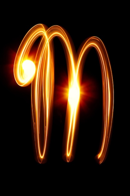 M - Created by light alphabet over black background