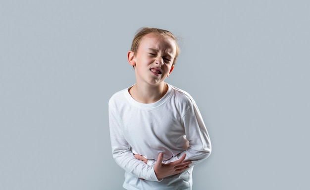 Maagpijn Tienerjongen met buikpijn Kind heeft vreselijke pijn in maag Diarree of gastro-enteritis gezondheidsprobleem Kind heeft buikpijn met voedselvergiftiging Kind hand in hand op buik