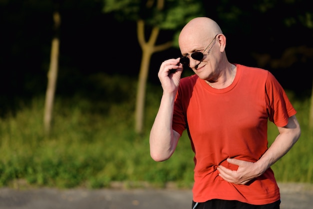 Maagpijnaandoeningen, oude man houdt zijn handen op zijn buik, gezondheidszorg en medisch concept