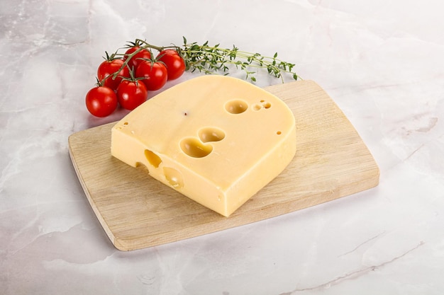 Maasdam cheese brick over board