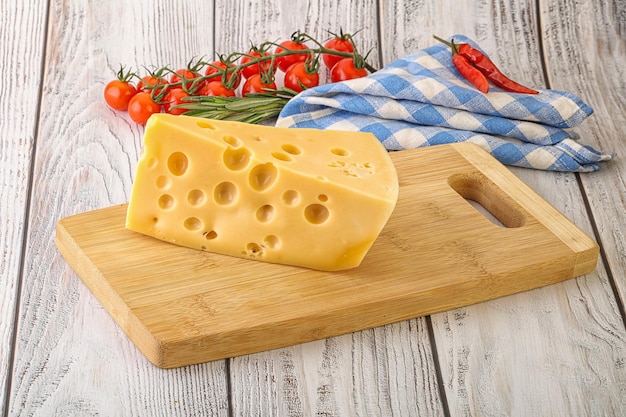 Maasdam cheese piece over board