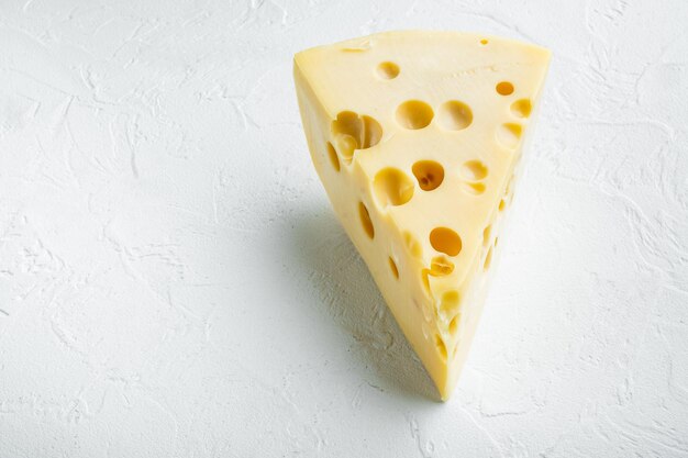 Maasdam cheese set, on white stone  surface, with copy space for text