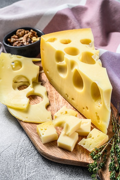 Maasdam cheese with holes, dairy yellow triangle.