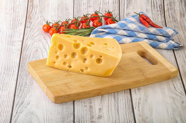 Maasdam organic cheese piece over board