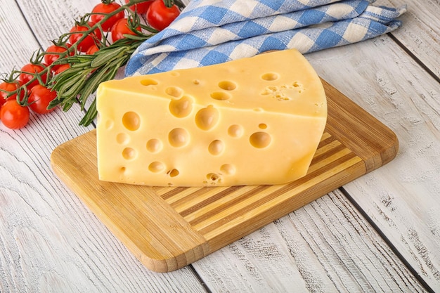 Maasdam organic cheese piece over board