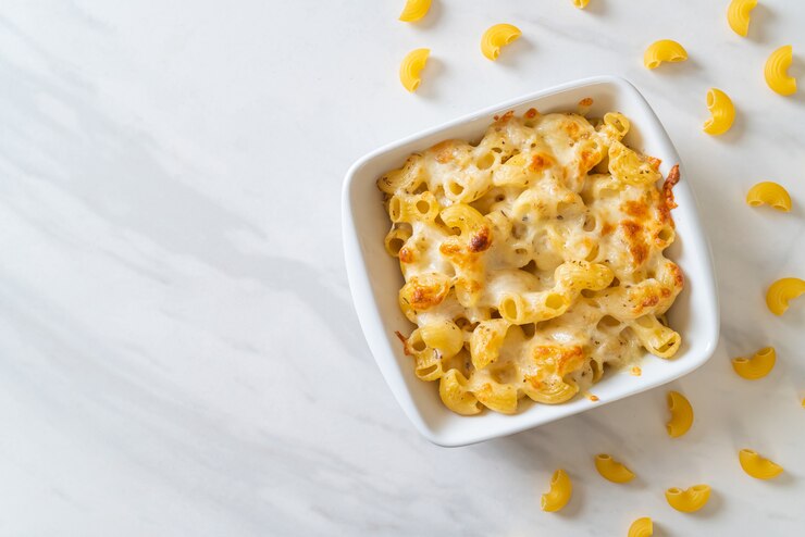mac and cheese, macaroni pasta in cheesy sauce - American style