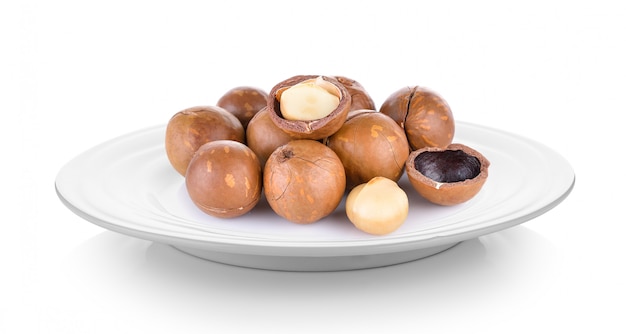 Macadamia nut in plate on white space