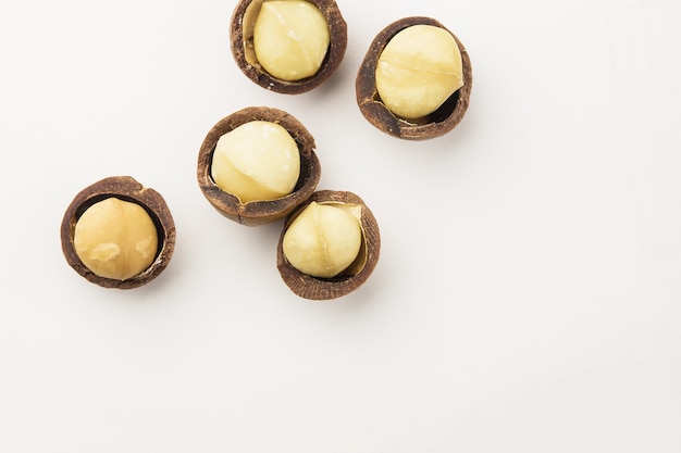 Macadamia nuts in a school isolated on white background