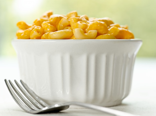 Macaroni and cheese close up on table with fork