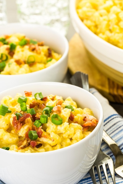 Macaroni and cheese garnished with bacon bits and chives.