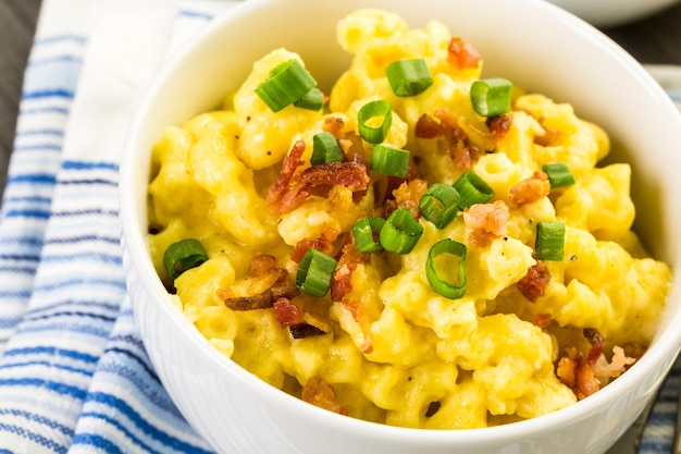 Macaroni and cheese garnished with bacon bits and chives.