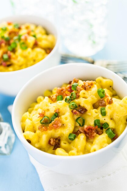 Macaroni and cheese garnished with bacon bits and chives.