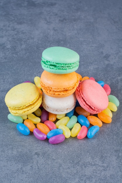 Macaroni cookies of different colors placed on jelly beans