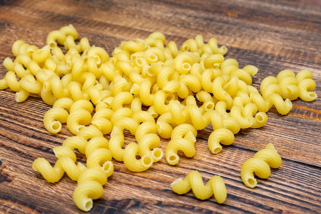 Macaroni, pasta on wooden table