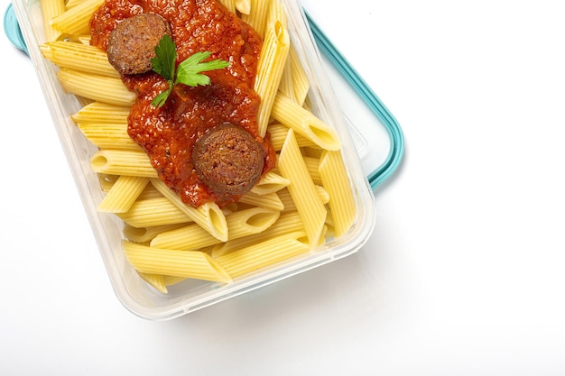 Macaroni with tomato sauce chorizo and cheese in plastic container