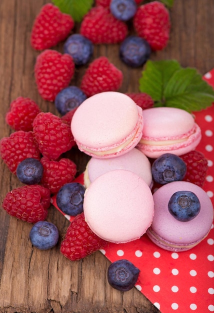 Macarons bosbessen en frambozen op een houten ondergrond