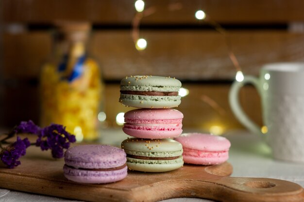 Macarons and cup of coffee on wooden table