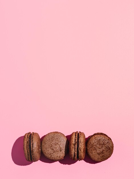 Photo macarons on pink copy space hard light